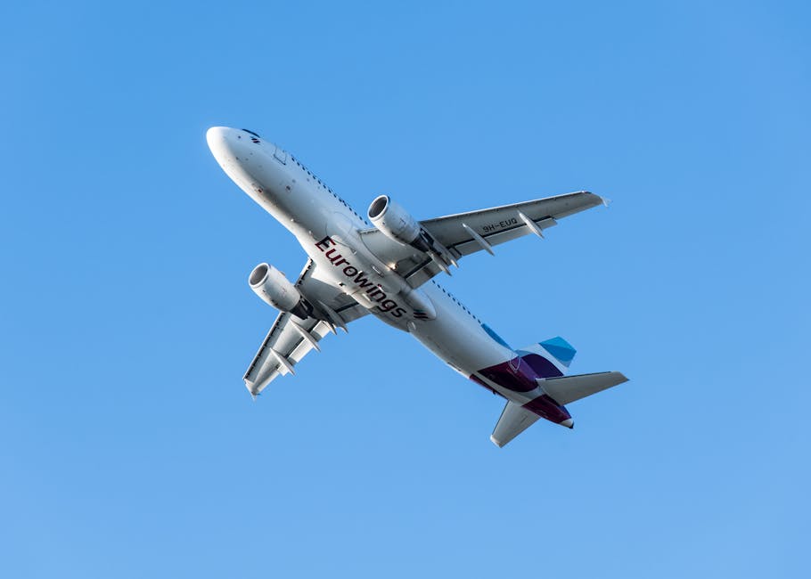Eurowings aircraft soaring in a bright blue sky, captured from below in flight.