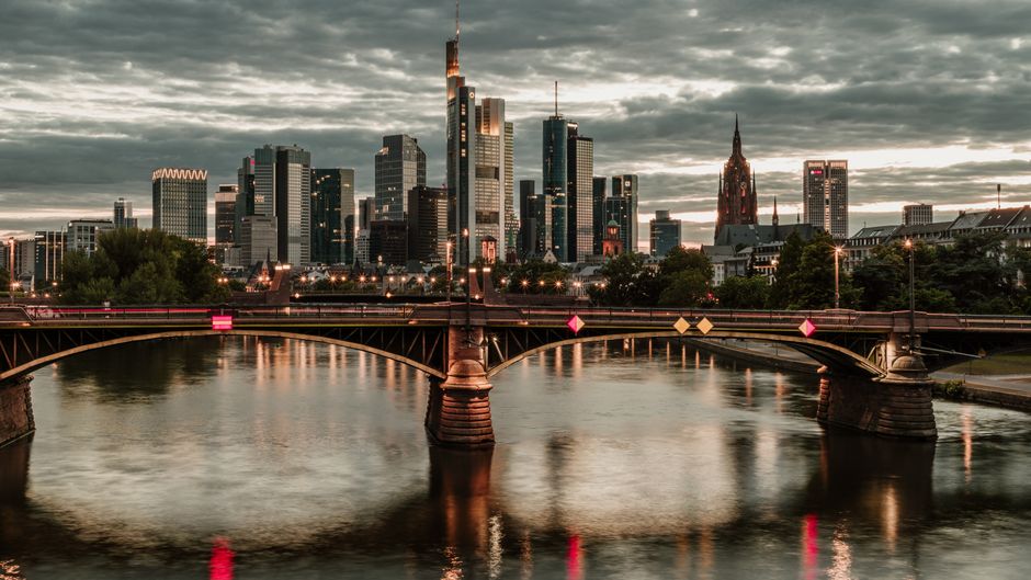 Stunning view of Frankfurt am Main skyline with reflections on the river at twilight.