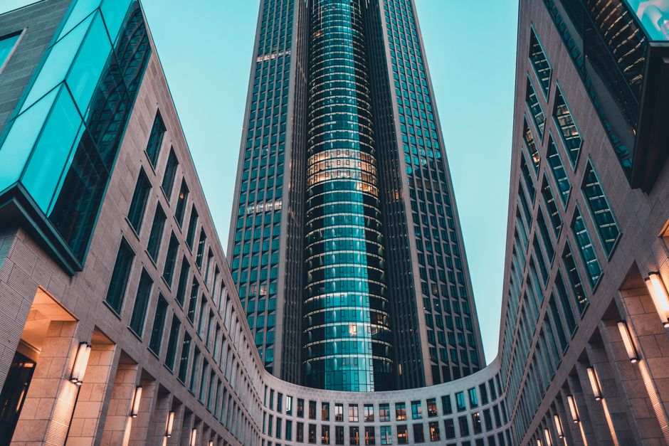 Contemporary urban skyscraper showcases sleek geometric architecture in cityscape.