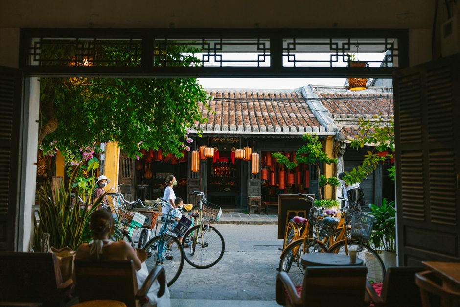 Explore a quaint Asian street scene featuring bicycles parked outside a traditional café.