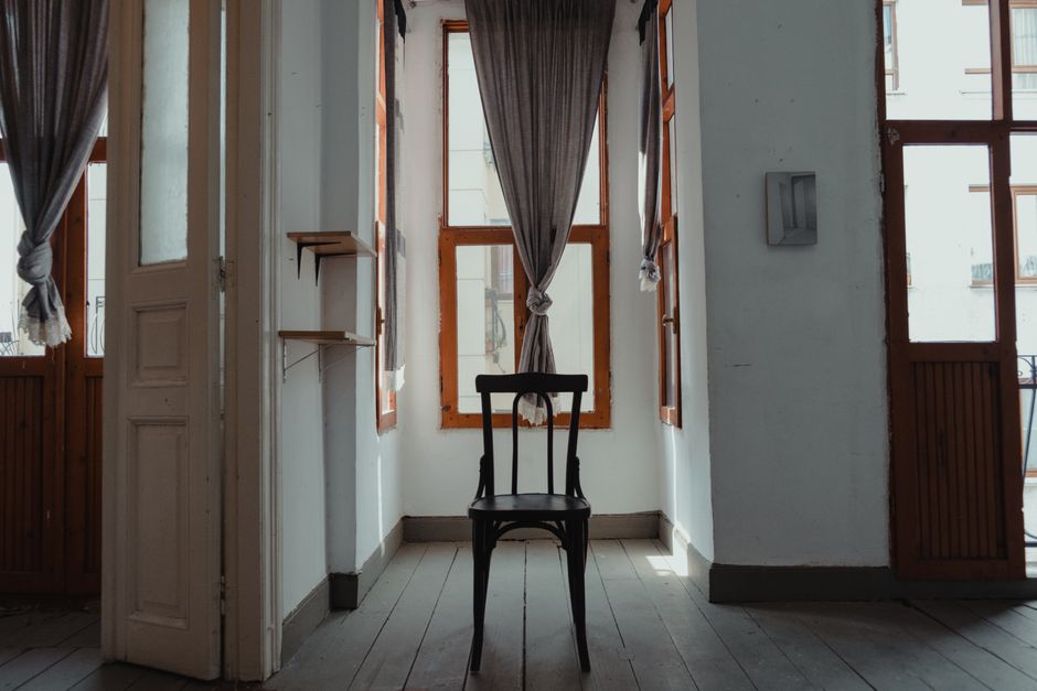Stylish interior with a vintage wooden chair, curtains, and decor.