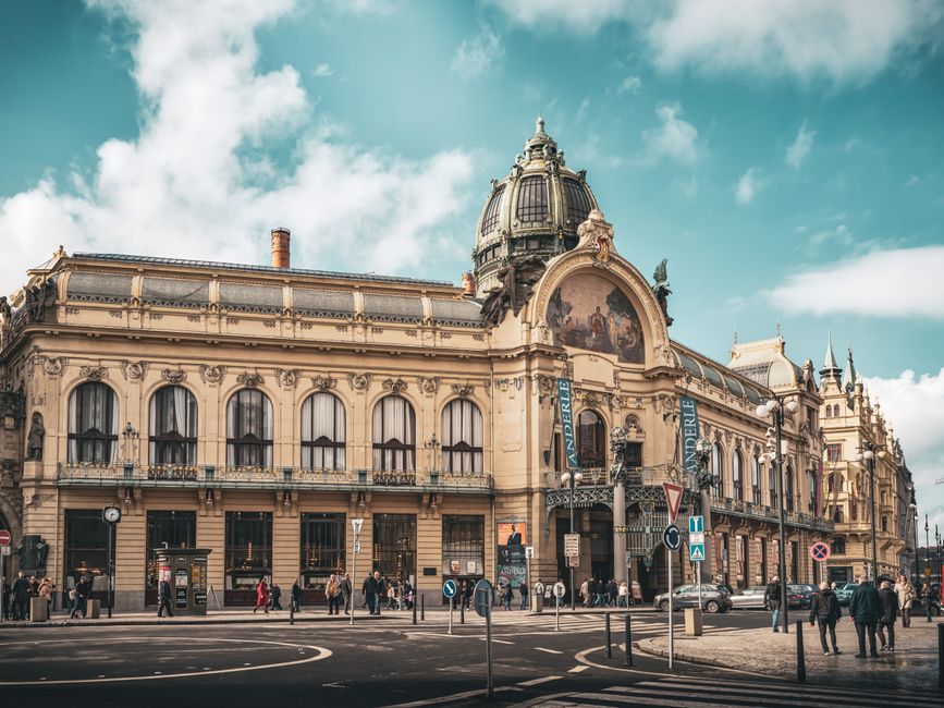 Stunning view of the famed Municipal House in Prague with Art Nouveau architecture under a bright sky.