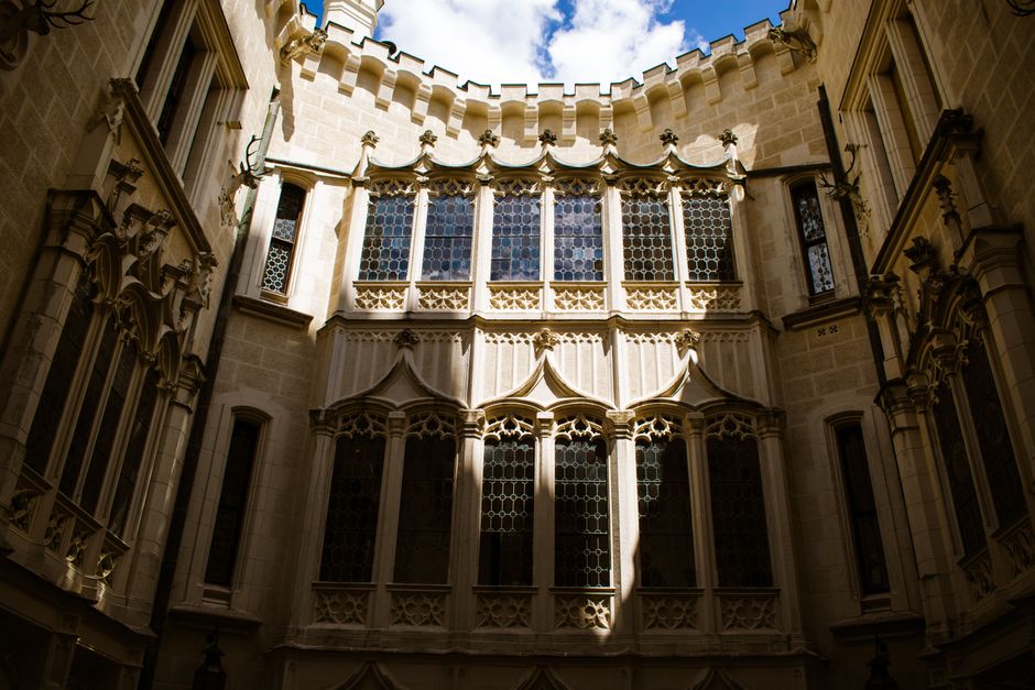 Stunning Gothic-style facade with intricate windows in a historic Czech building.