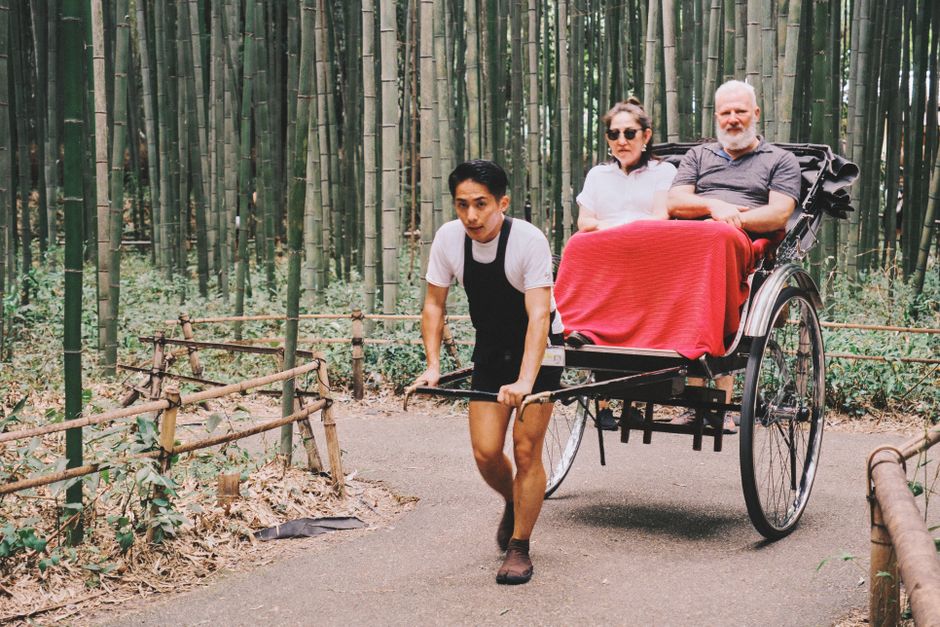 Experience a serene rickshaw journey through the iconic bamboo groves of Kyoto, Japan.