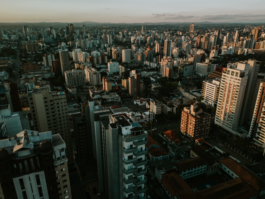Stunning aerial view of Curitiba skyline at sunset featuring modern skyscrapers.