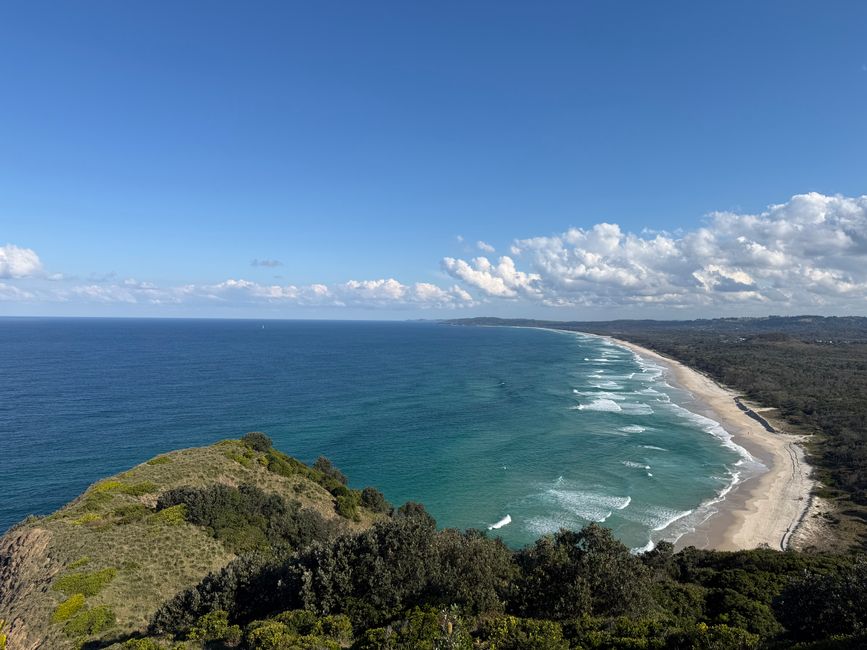 Stunning aerial photo of Byron Bay coastline with lush greenery and expansive ocean under 
