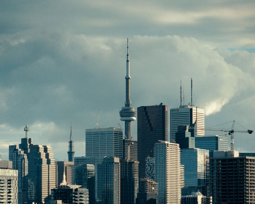 Stunning view of Toronto's skyline featuring the iconic CN Tower under cloudy skies.