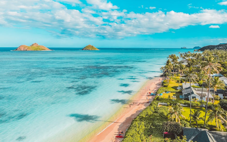 Serene tropical beach scene with palm trees, turquoise sea, and distant islands, perfect for a summer getaway.